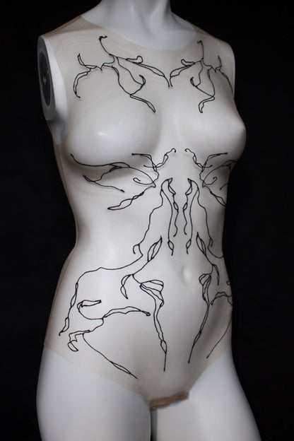 Mannequin torso with black abstract designs on a black background