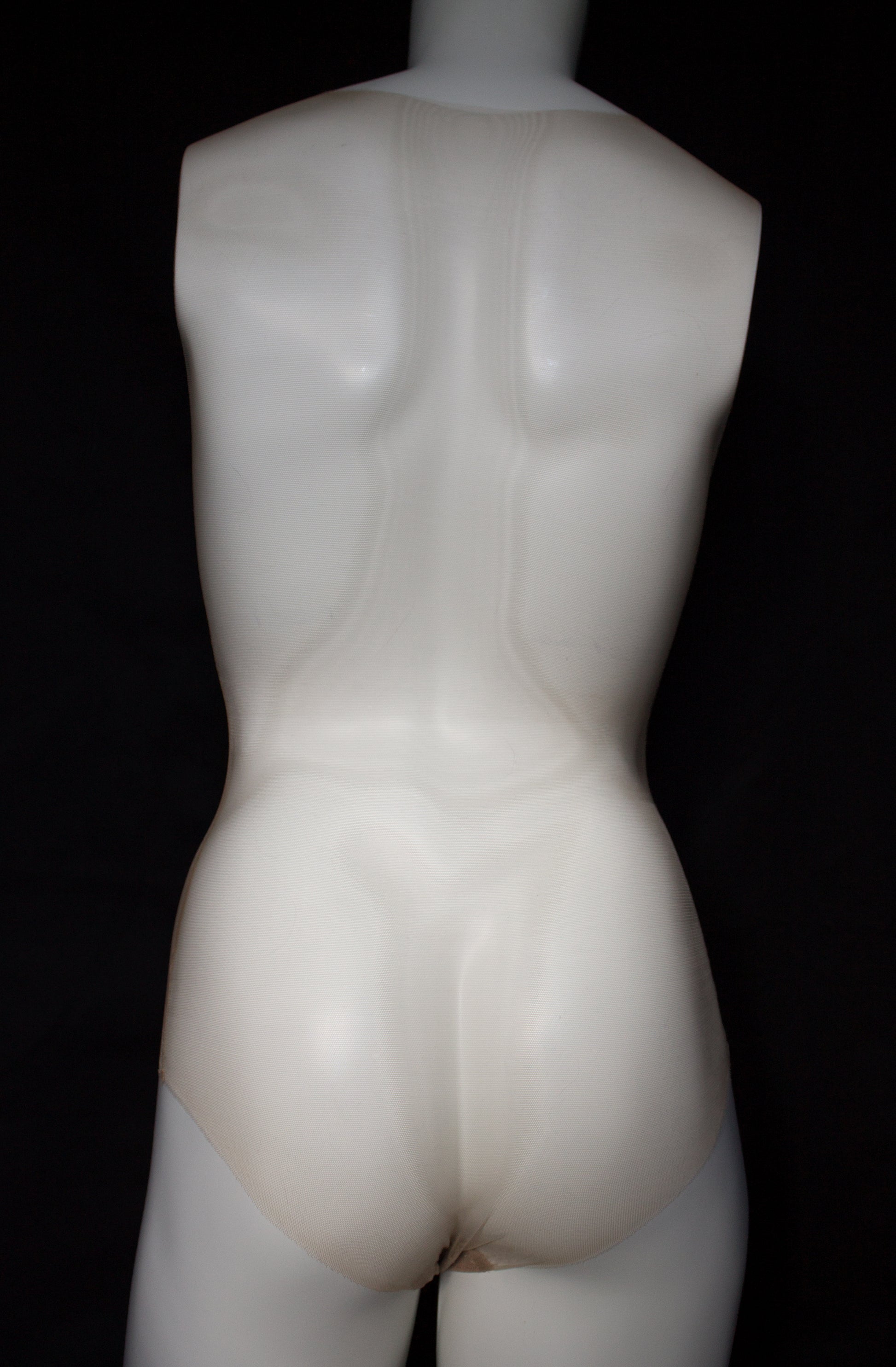 Mannequin torso on a black background