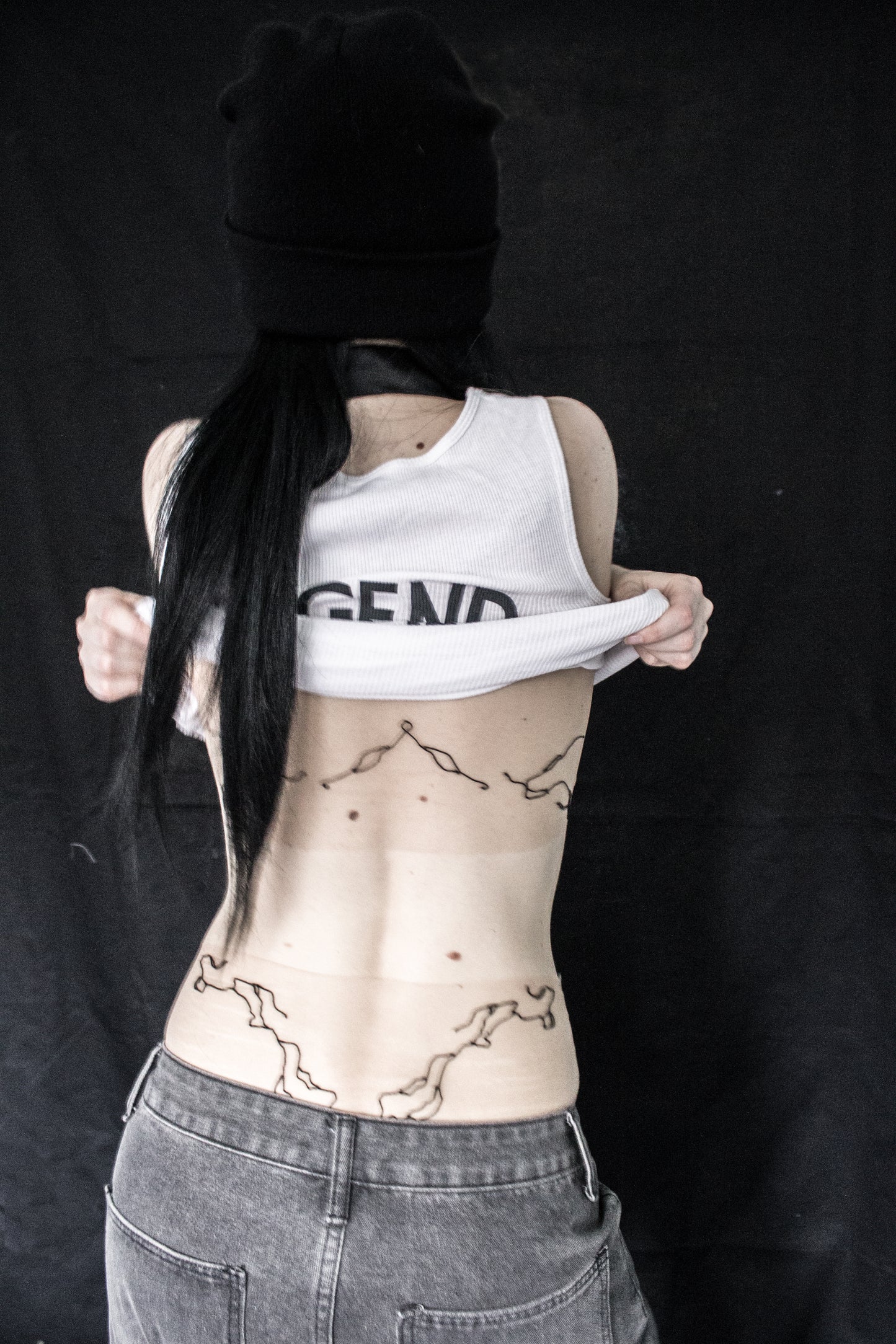 Person with tattoos on a black background