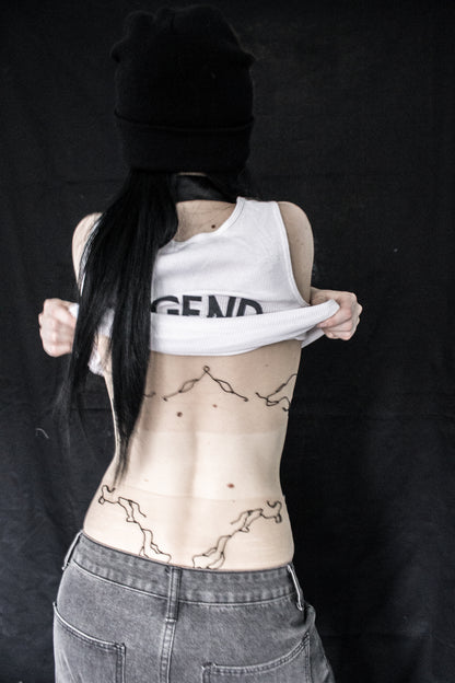 Person with tattoos on a black background