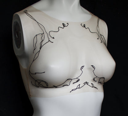 Mannequin torso with black line art design on a white background
